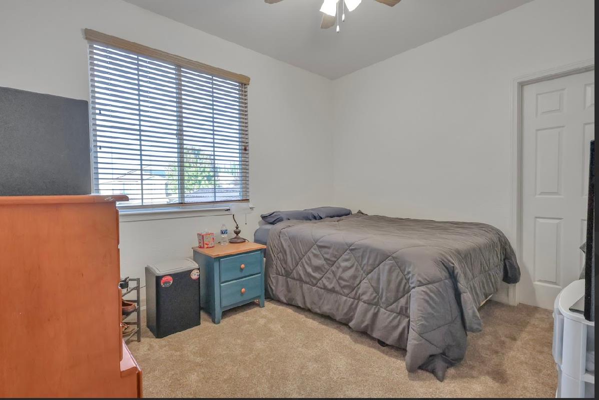 10647 Spring Creek Place Stockton, CA 95209 - Photo 18 of 24 a bedroom with a bed and a window