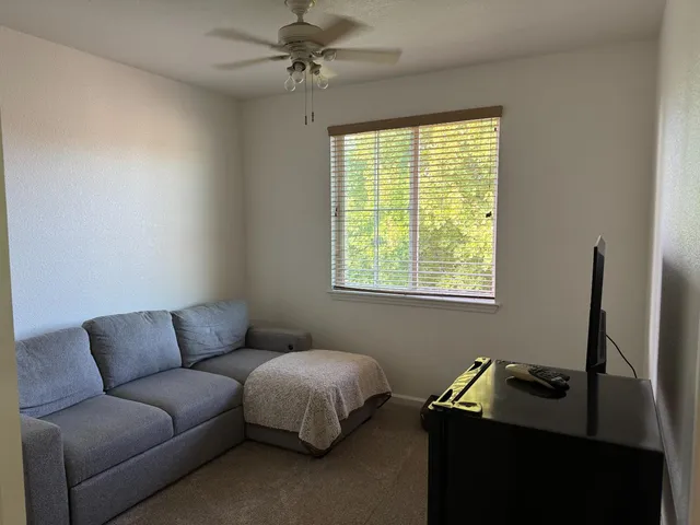 a living room with furniture and a window
