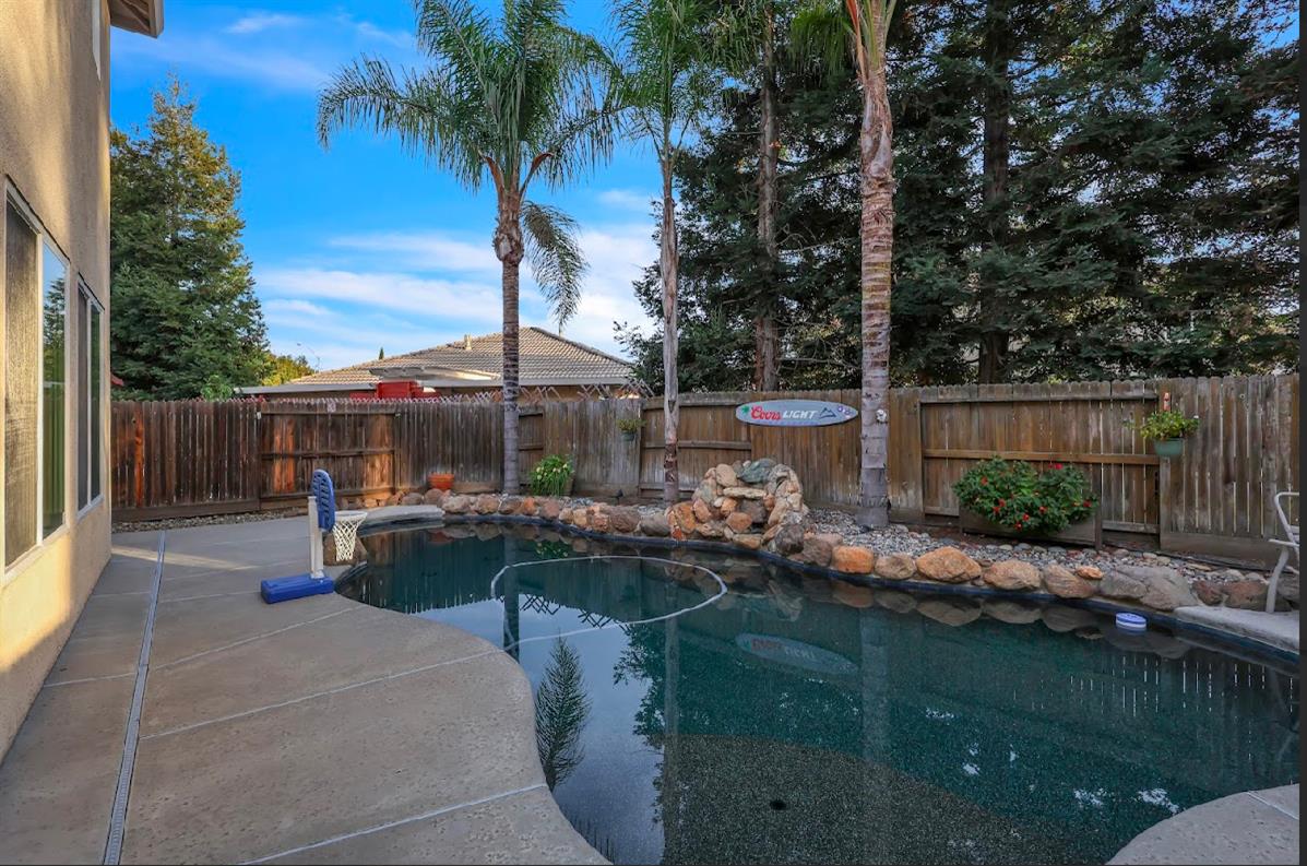 10647 Spring Creek Place Stockton, CA 95209 - Photo 21 of 24 a view of swimming pool with outdoor seating and plants
