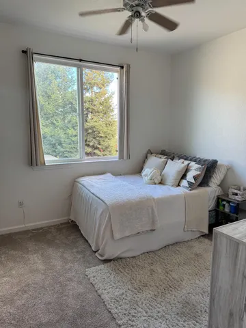 a bedroom with a bed and window