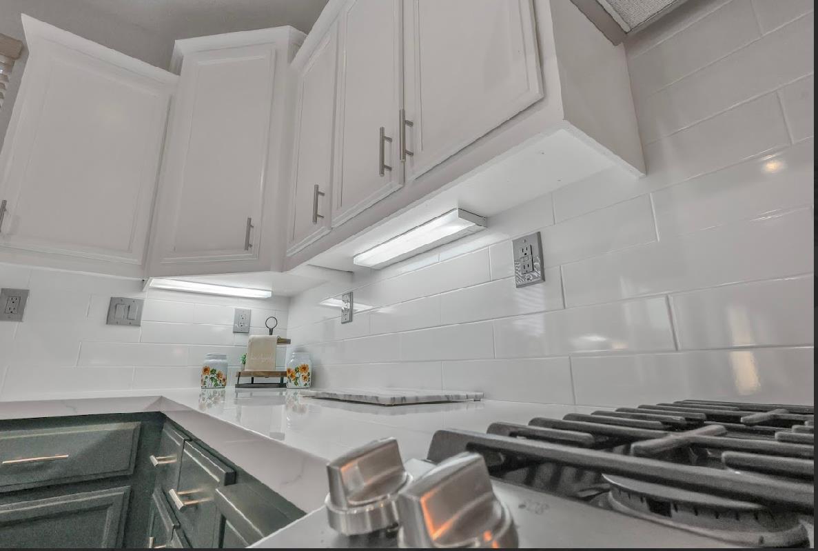 10647 Spring Creek Place Stockton, CA 95209 - Photo 23 of 24 a kitchen with a stove and a cabinets