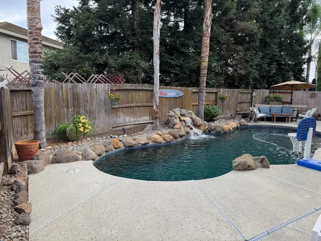 a view of a house with backyard and sitting area