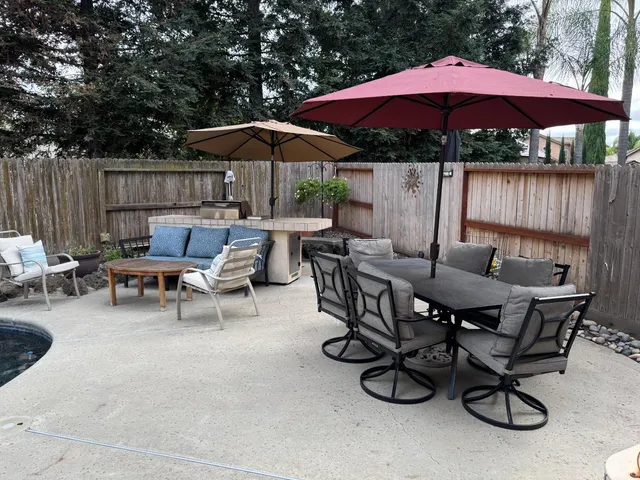 a view of backyard with outdoor seating and wooden floor