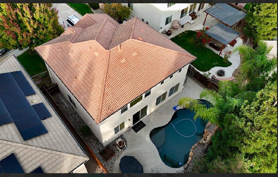 10647 Spring Creek Place Stockton, CA 95209 - Photo 3 of 24 an aerial view of a house with chairs and wooden fence
