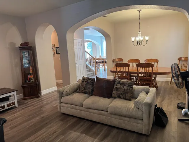 a living room with furniture a fireplace and wooden floor