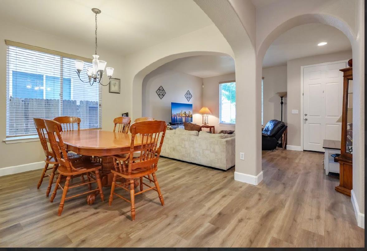 10647 Spring Creek Place Stockton, CA 95209 - Photo 5 of 24 a dining room with furniture and wooden floor
