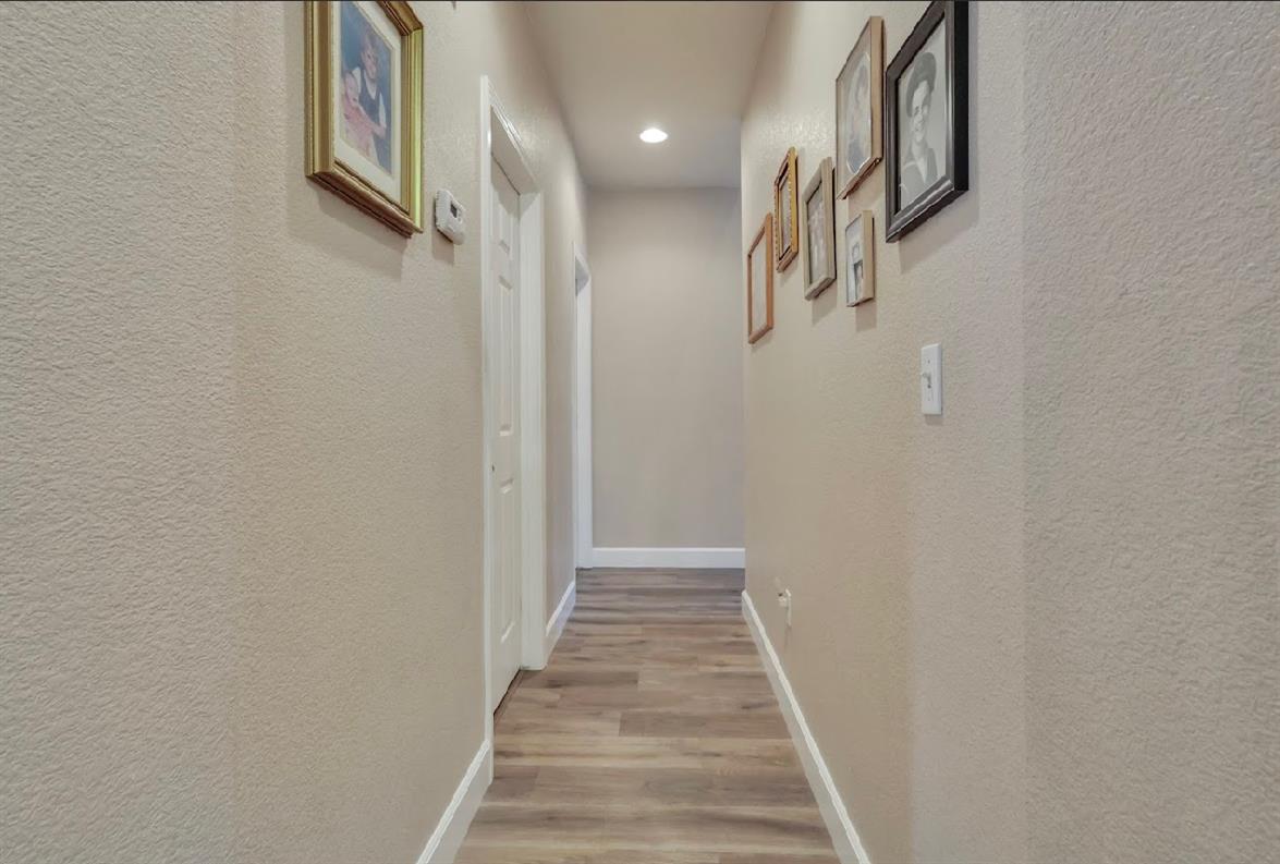 10647 Spring Creek Place Stockton, CA 95209 - Photo 6 of 24 a view of a hallway with wooden floor