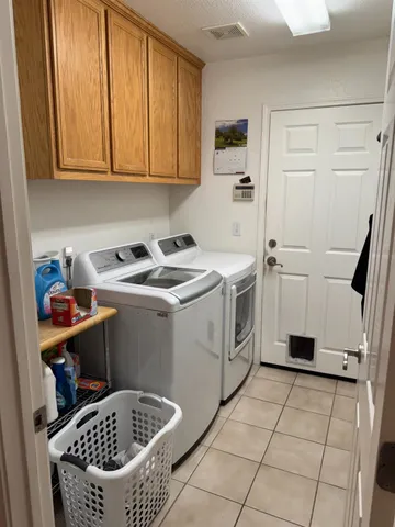 a utility room with sink dryer and washer