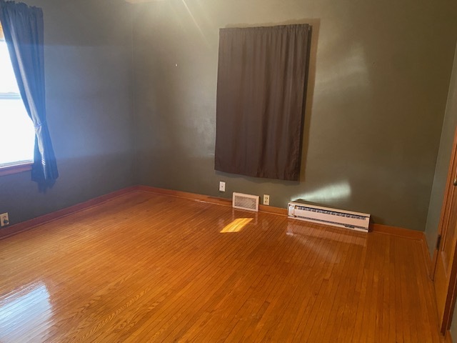 312 Walnut Street Leonore, IL 61332 - Photo 11 of 13 an empty room with wooden floor