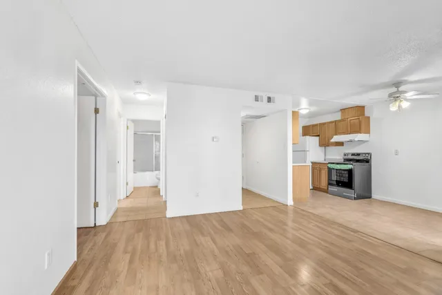 a view of a kitchen with a sink and a refrigerator