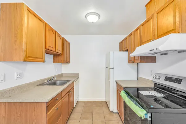 a kitchen with a sink and a stove top oven