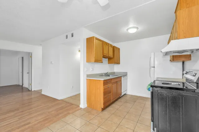 a kitchen with granite countertop a sink and a stove top oven