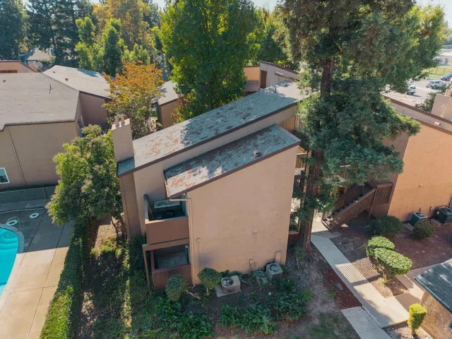 an aerial view of a house with a swimming pool