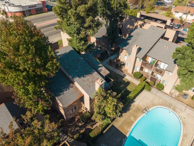 an aerial view of residential house with outdoor space and swimming pool