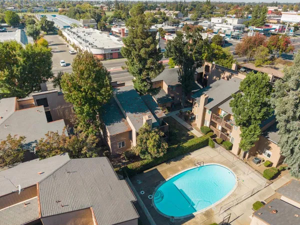 an aerial view of a house with a yard