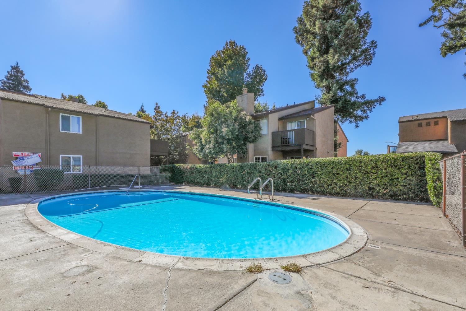 4332 Pacific Avenue, Unit 25 Stockton, CA 95207 - Photo 8 of 38 a view of a swimming pool with a yard