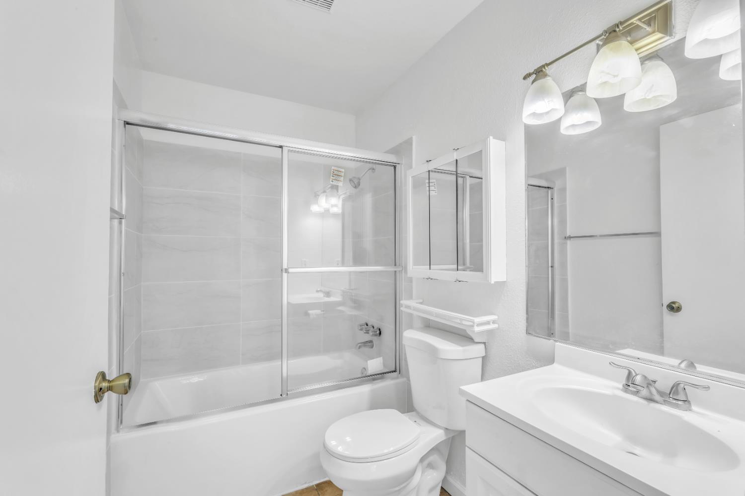 4332 Pacific Avenue, Unit 25 Stockton, CA 95207 - Photo 9 of 38 a bathroom with a sink a toilet and shower