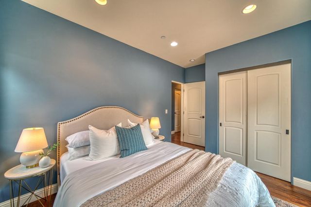 a living room with wooden floor and a fireplace