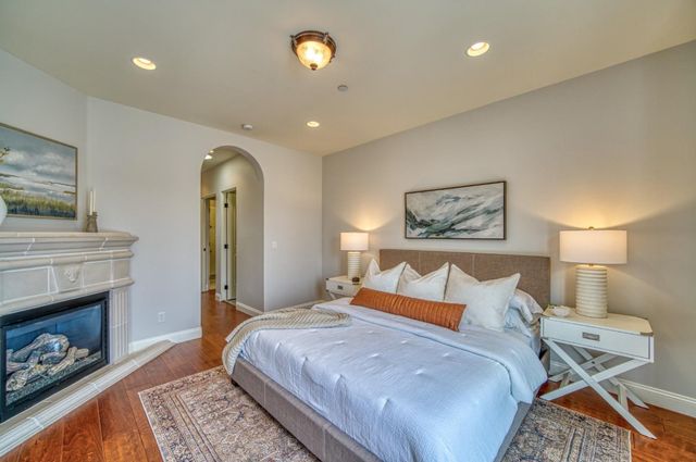 a bedroom with a bed and a dresser next to a window