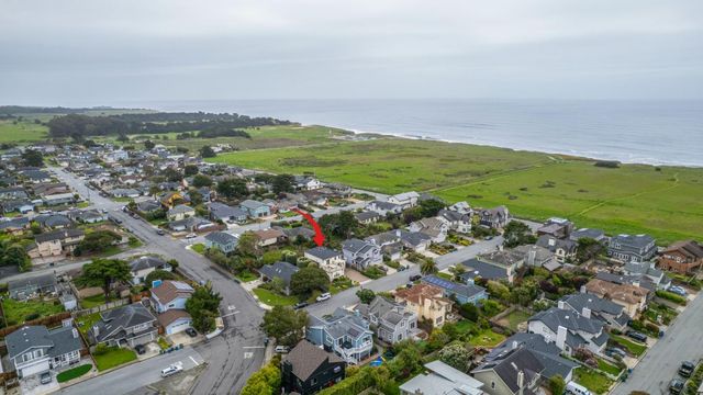 an aerial view of a residential building with outdoor space and seating area
