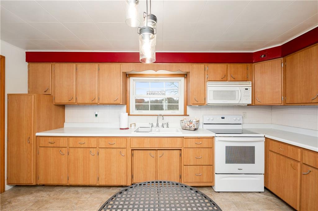 1080 Breakneck Bridge Road Portersville, PA 16051 - Photo 17 of 45 a kitchen with a stove a sink and a microwave