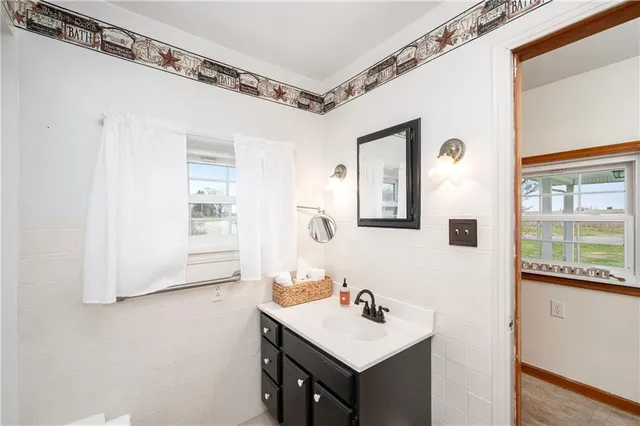 a bathroom with a sink a mirror and a window