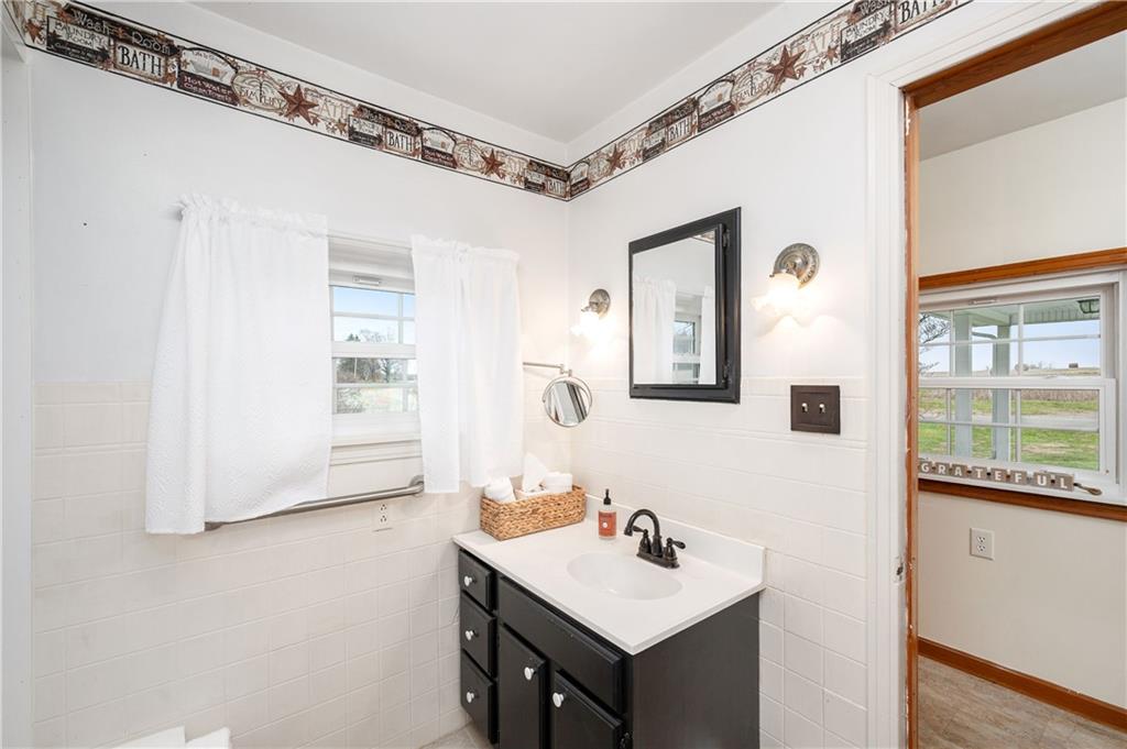 1080 Breakneck Bridge Road Portersville, PA 16051 - Photo 21 of 45 a bathroom with a sink a mirror and a window