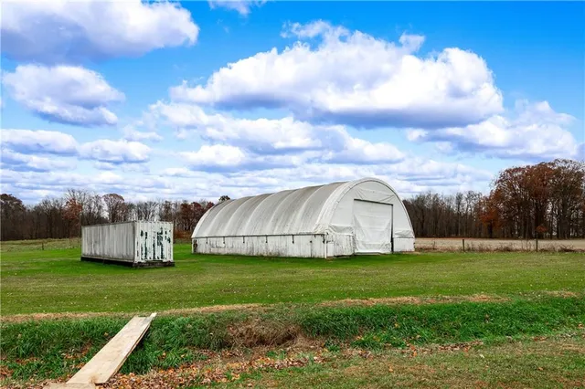 a view of a garden with wooden fence