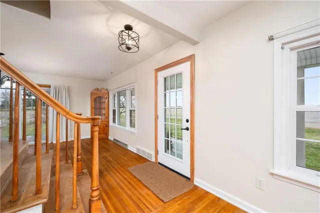 a view of an entryway with wooden floor