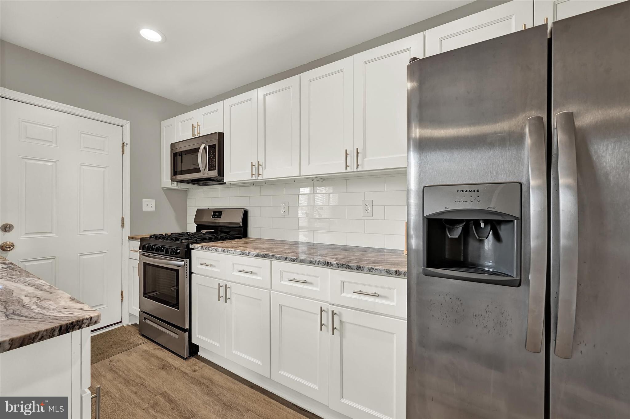 3482 Dunhaven Road Dundalk, MD 21222 - Photo 12 of 33 a kitchen with cabinets stainless steel appliances and a counter top space
