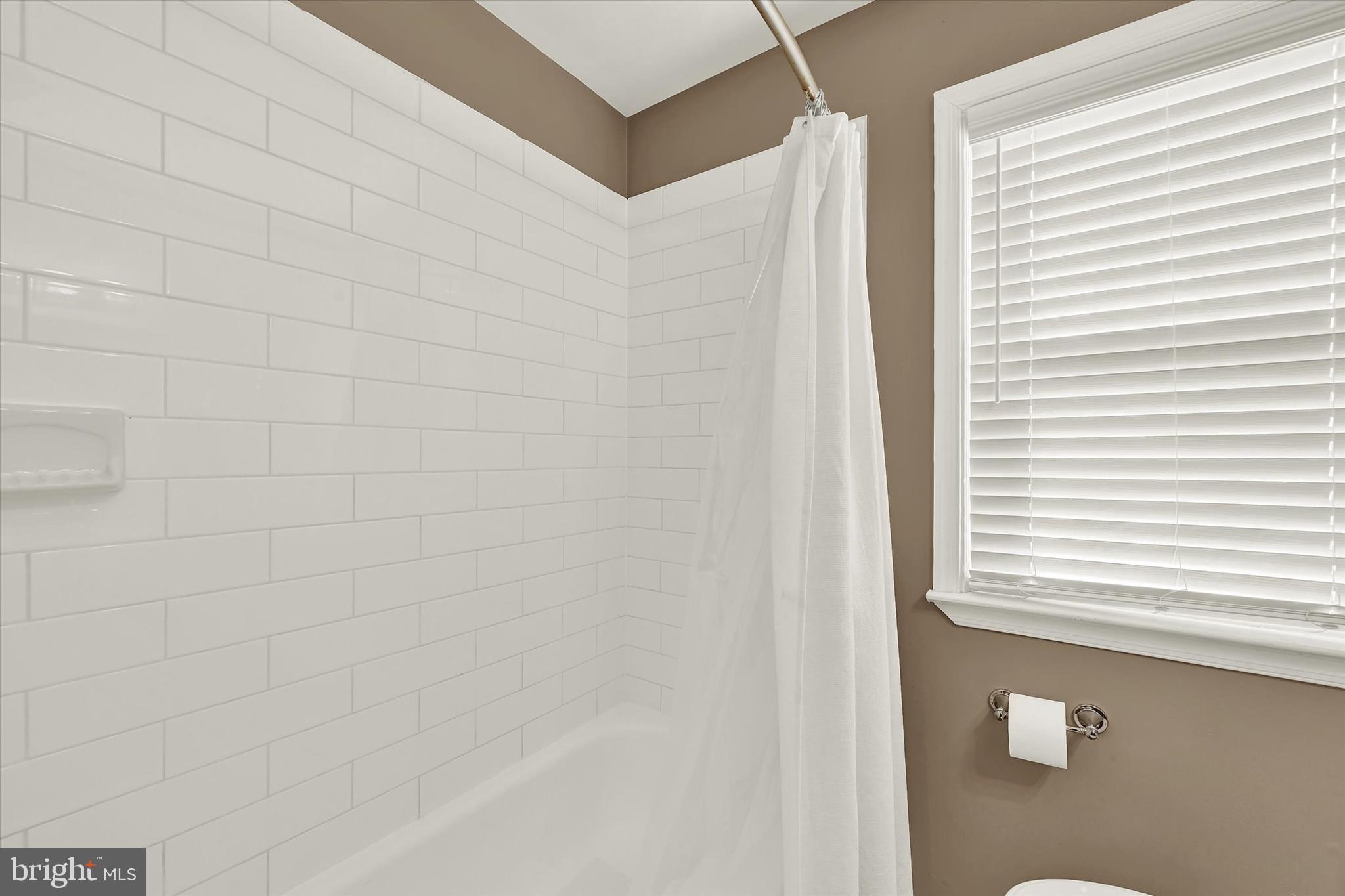 3482 Dunhaven Road Dundalk, MD 21222 - Photo 14 of 33 a bathroom with a shower and a window