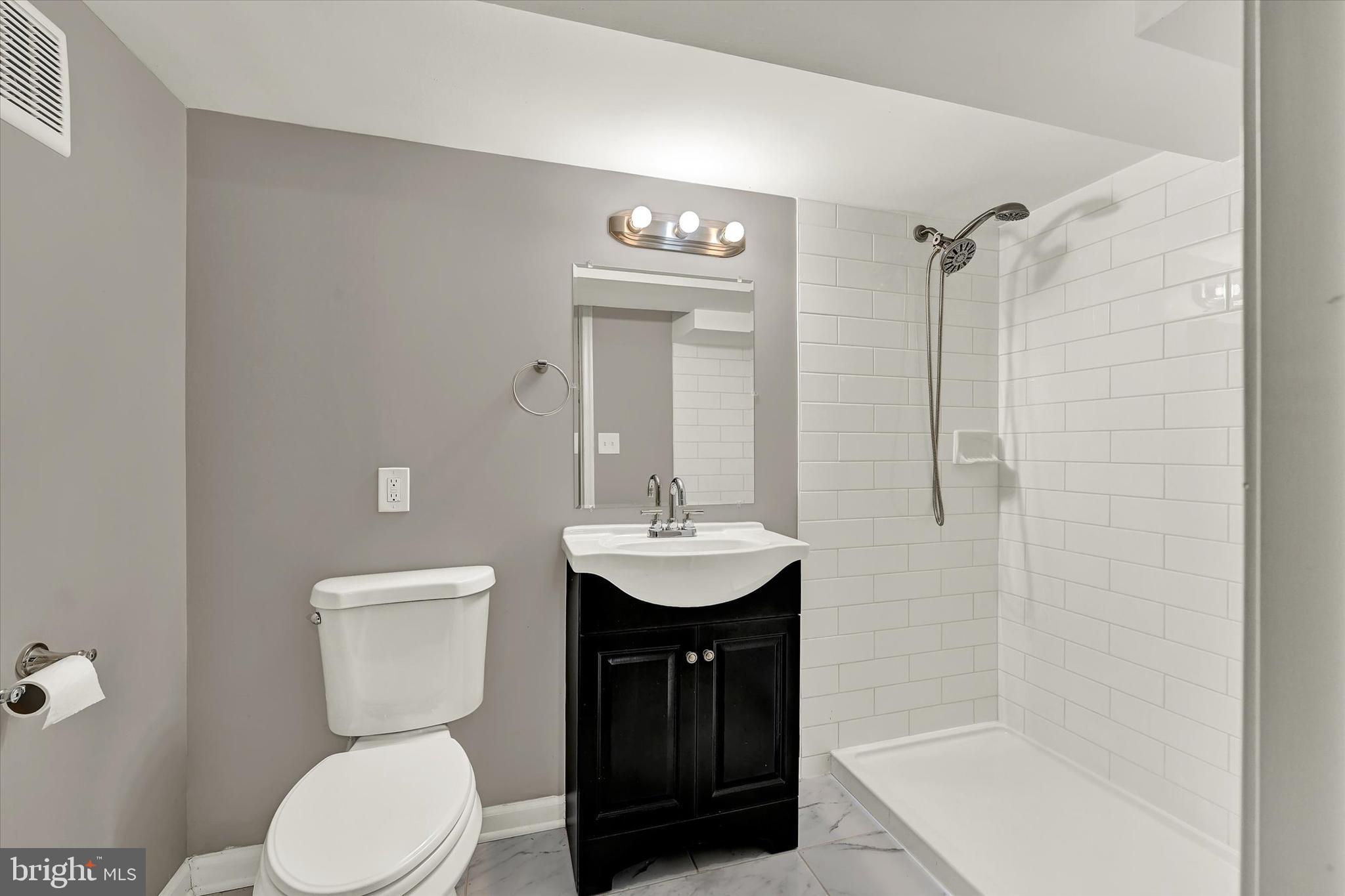 3482 Dunhaven Road Dundalk, MD 21222 - Photo 21 of 33 a bathroom with a sink a toilet and shower