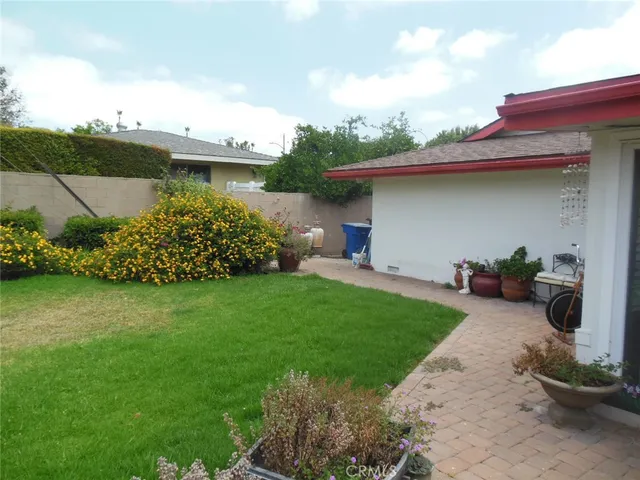 a front view of a house with a garden and plants