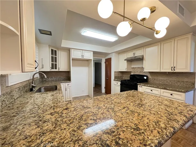 a large kitchen with kitchen island sink refrigerator and cabinets