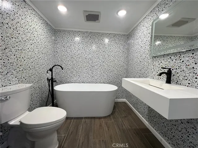 a bathroom with a toilet a sink and bathtub