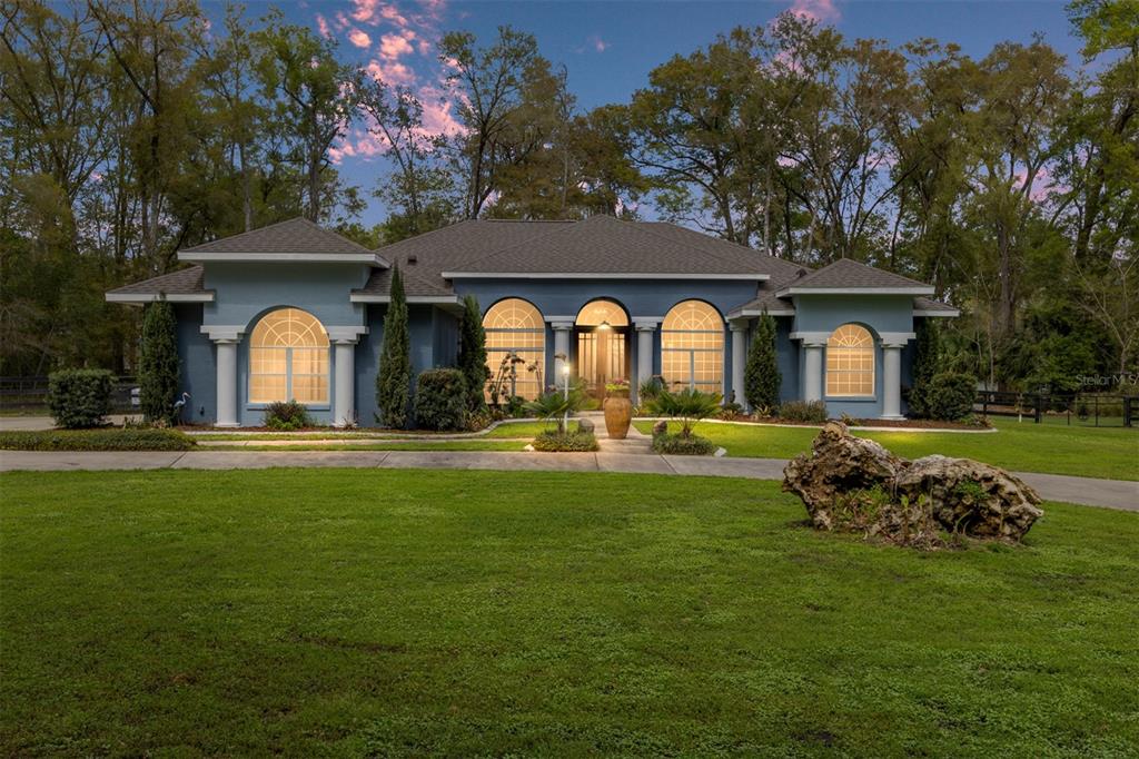 a front view of a house with a garden