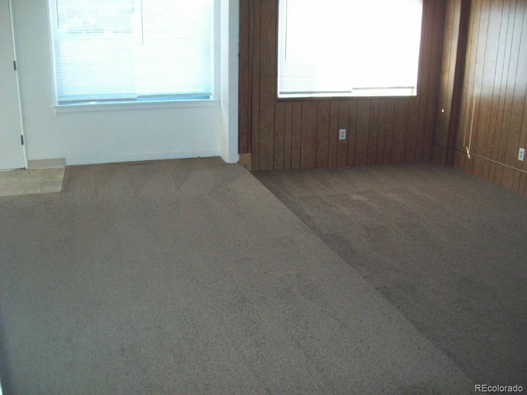 1930 Ulster Street Denver, CO 80220 - Photo 3 of 9 an empty room with window