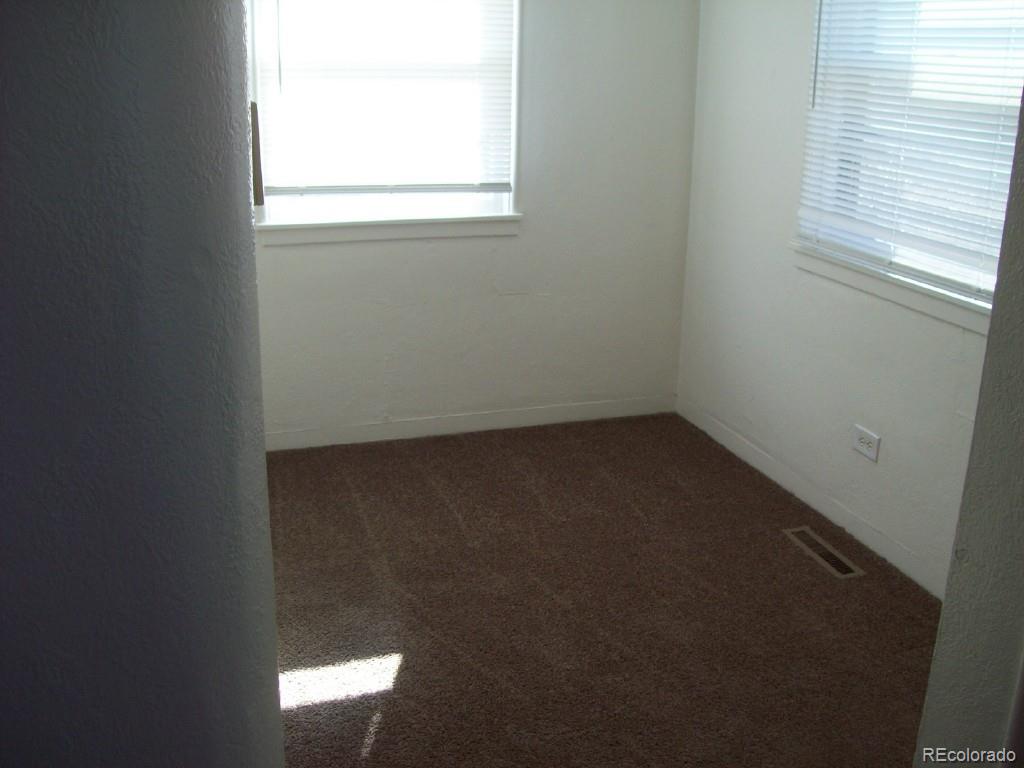 1930 Ulster Street Denver, CO 80220 - Photo 4 of 9 an empty room with a window