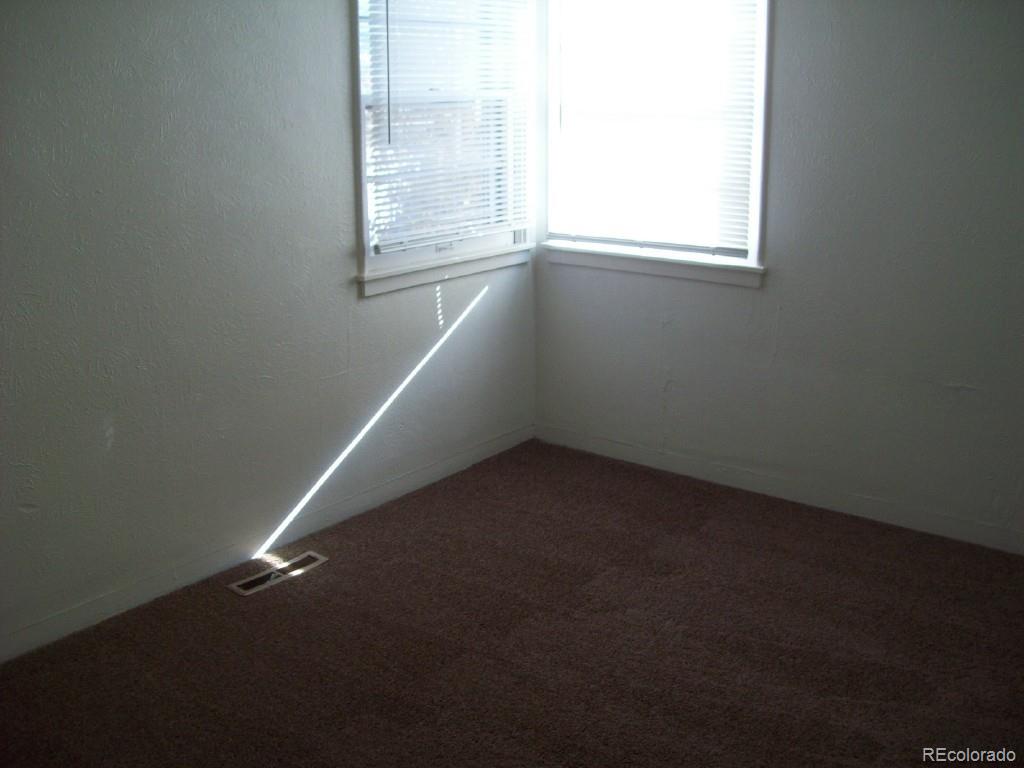 1930 Ulster Street Denver, CO 80220 - Photo 8 of 9 an empty room with a window