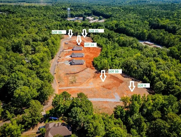 an aerial view of a house with a yard and lake view