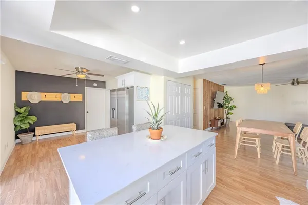 a kitchen with sink and view of living room
