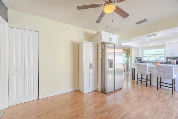 a view of kitchen with stainless steel appliances refrigerator microwave and stove