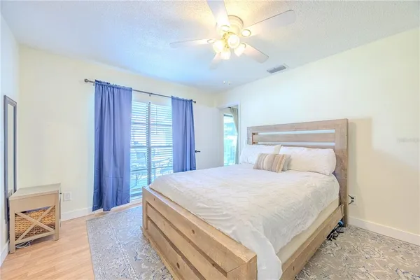 a bedroom with a large bed and a chandelier