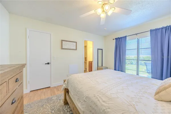 a bedroom with a large bed and a chandelier