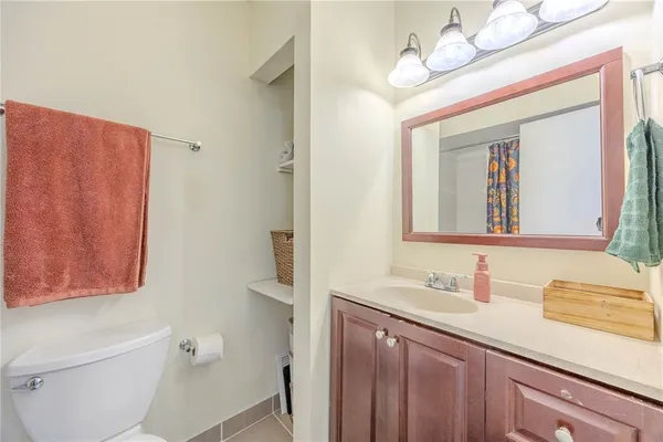 a bathroom with a sink a toilet and a mirror