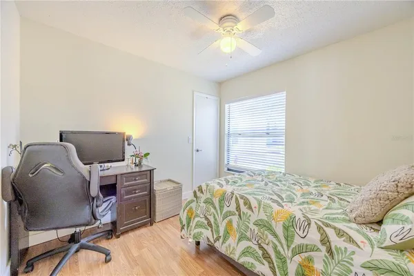 a bedroom with a bed and a chair