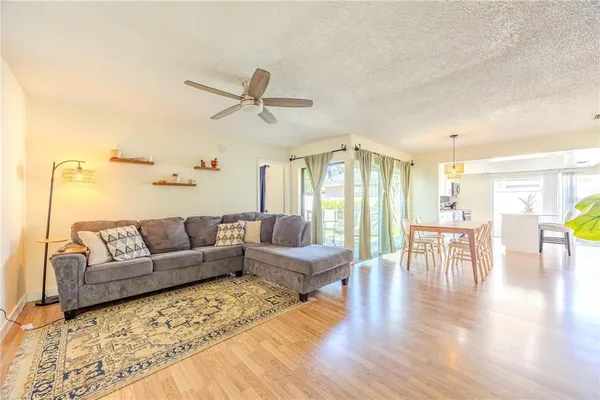 a living room with furniture and a wooden floor