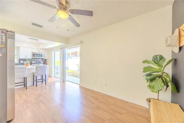 a dining room with furniture and a potted plant