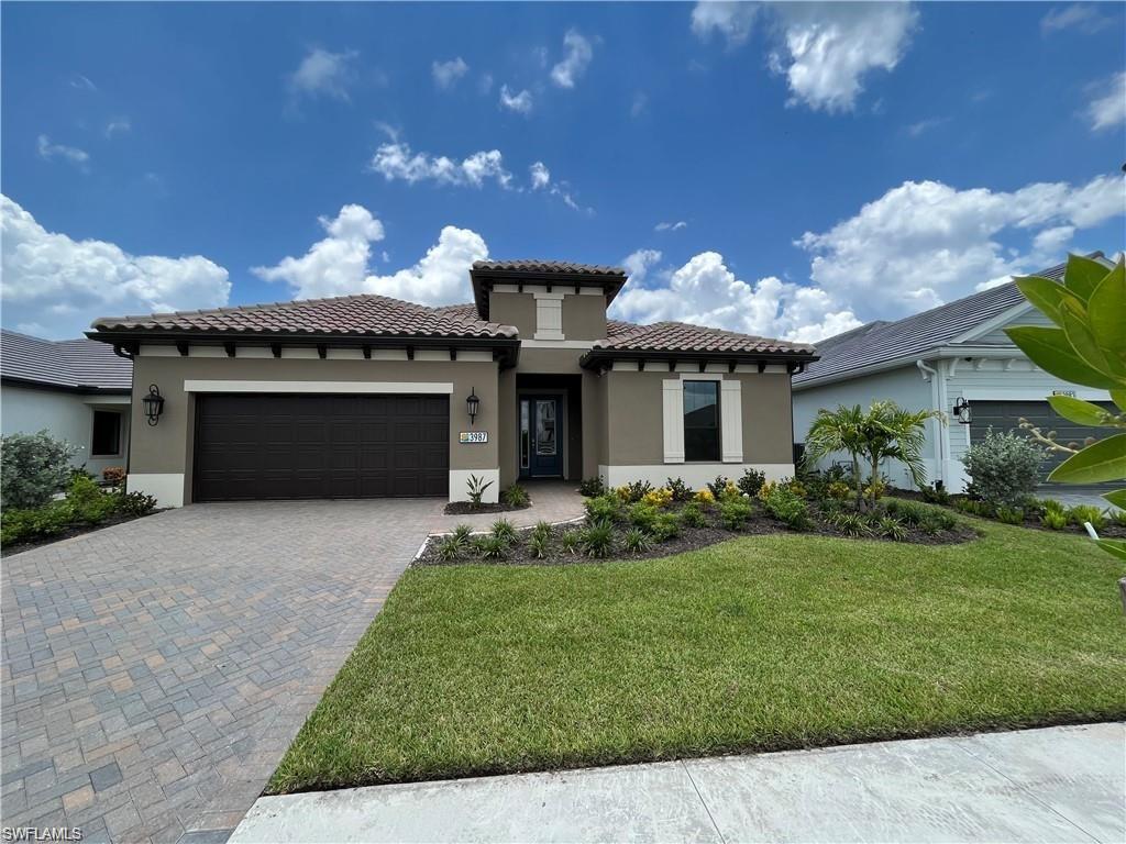 3987 Pegasus Way Naples, FL 34120 - Photo 1 of 8 a front view of a house with a garden and plants
