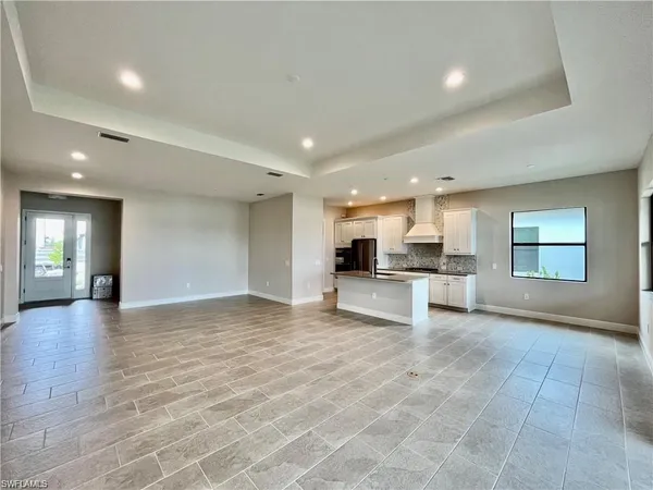 a view of kitchen with refrigerator and window